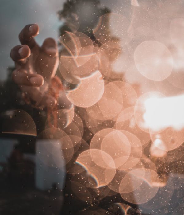 Silhouette of a person meditating against a warm, glowing background.